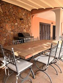 Tavolo in pietra piu sedie in ferro battuto.