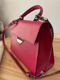 Borsa Coccinelle rosa a mano e a tracolla