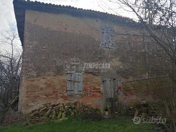 Porzione di quadrifamiliare con terreno agricolo a