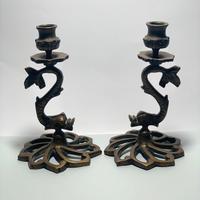 Antica coppia di candelieri con delfini in bronzo