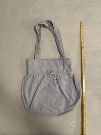 Borsa Subdued con fiocco a coste lilla chiaro.