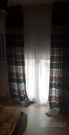 letto comodini lampadario in Swarovski più tenda