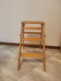 Sgabello pieghevole in legno con tre gradini.