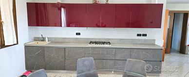 cucina con elettrodomestici più tavolo con sedie