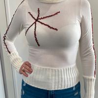 Maglia a collo alto color panna con paillettes