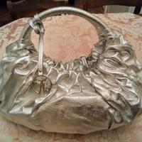 Borsa Coccinelle argento busta pochette zaino pell