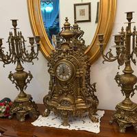 Trittico orologio e cadelieri