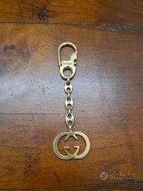 gucci portachiavi o accessorio per borsa,  meta.,