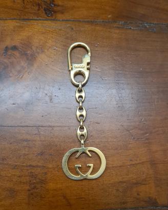 gucci portachiavi o accessorio per borsa,  meta.,