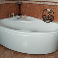 Vasca da bagno ad angolo con rubinetti in ottone 