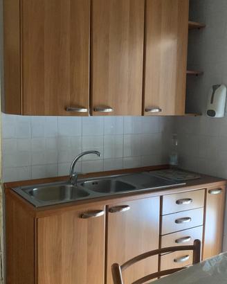 Cucina lineare completa con Frigorifero.