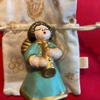 Thun Angelo con veste celeste e flauto dorato