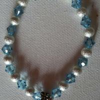 BRACCIALE ELASTICO *simbolo OHM*CON PERLE ARGENTO
