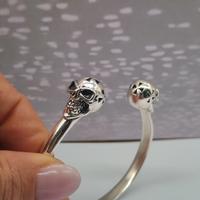Bracciale rigido con teschietti  argento 