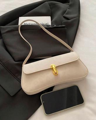 Borsa colore neutro con dettaglio in oro