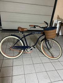 Bicicletta cruiser blu con manopole in pelle