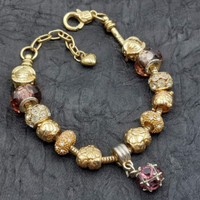 Bracciale multicharms oro e viola portafortuna ?