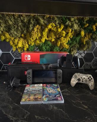nintendo switch con pokemon, controller e altro