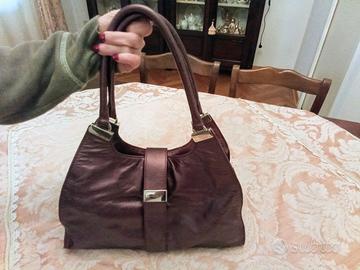 Borsa Coccinelle busta pochette zaino melanzana