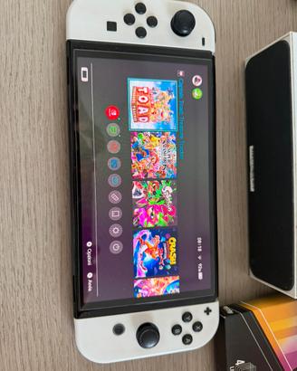 Nintendo switch oled con accessori e gioco.