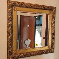 Specchio con cornice in legno.