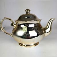 teiera in porcellana smaltata color oro