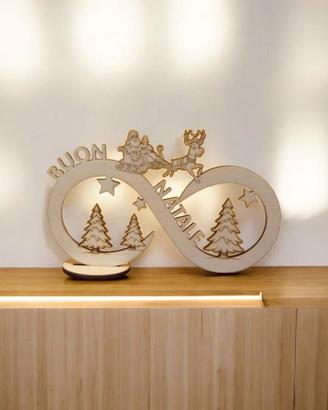 infinito con slitta di babbo natale su legno