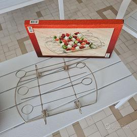 Supporto giraspiedini per barbecue