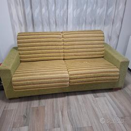 divano letto, tavolo vetro e parete attrezzata