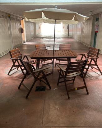 Tavolo da giardino con ombrellone e sedie