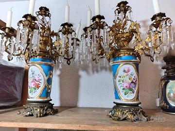 Due candelabri antichi in bronzo e porcellana