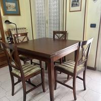 Tavolo in legno scuro allungabile completo di sedi