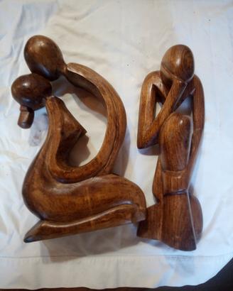coppia di sculture in legno massello intagliate a 