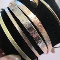 5 Bracciali in argento dorato