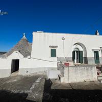 Ancient manor house with stone trulli and lamie