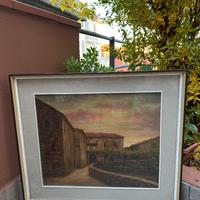 Strada di paese con case di sasso al tramonto