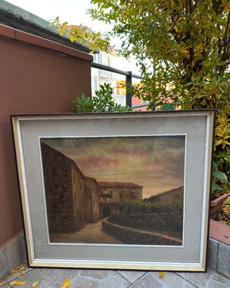 Strada di paese con case di sasso al tramonto