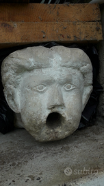 Fontana,testa in pietra scolpita