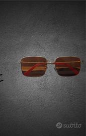 Occhiali da sole lente arancione aste dorate v
