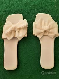 ciabatte di pelle bianca con fiocco di raso