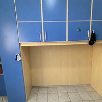 Cameretta con armadio a ponte blu e legno chiaro