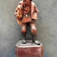 Statuina anri uomo con maialino