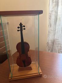 Violino in miniatura in teca di vetro