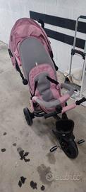 triciclo rosa con braccio