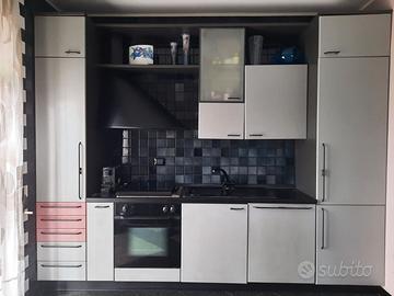 Cucina completa di elettrodomestici, tavolo, sedie
