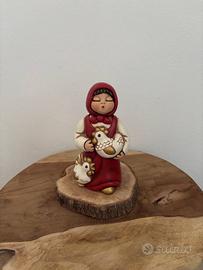 Donna con galline rossa presepe giubileo Thun