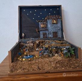 Presepe artigianale in scatola con luci e stelle