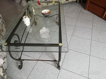 Tavolino da salone in vetro con base di metallo.