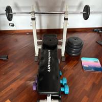 Panca con bilanciere e pesi