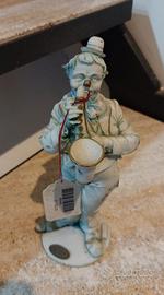 Statuina antica in porcellana Clown musicista